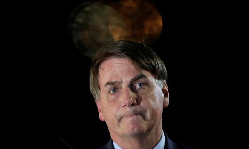 Brazil's President Jair Bolsonaro reacts while meeting supporters as he arrives at Alvorada Palace, amid Covid-19 outbreak, in Brasilia, Brazil. &mdash; Reuters