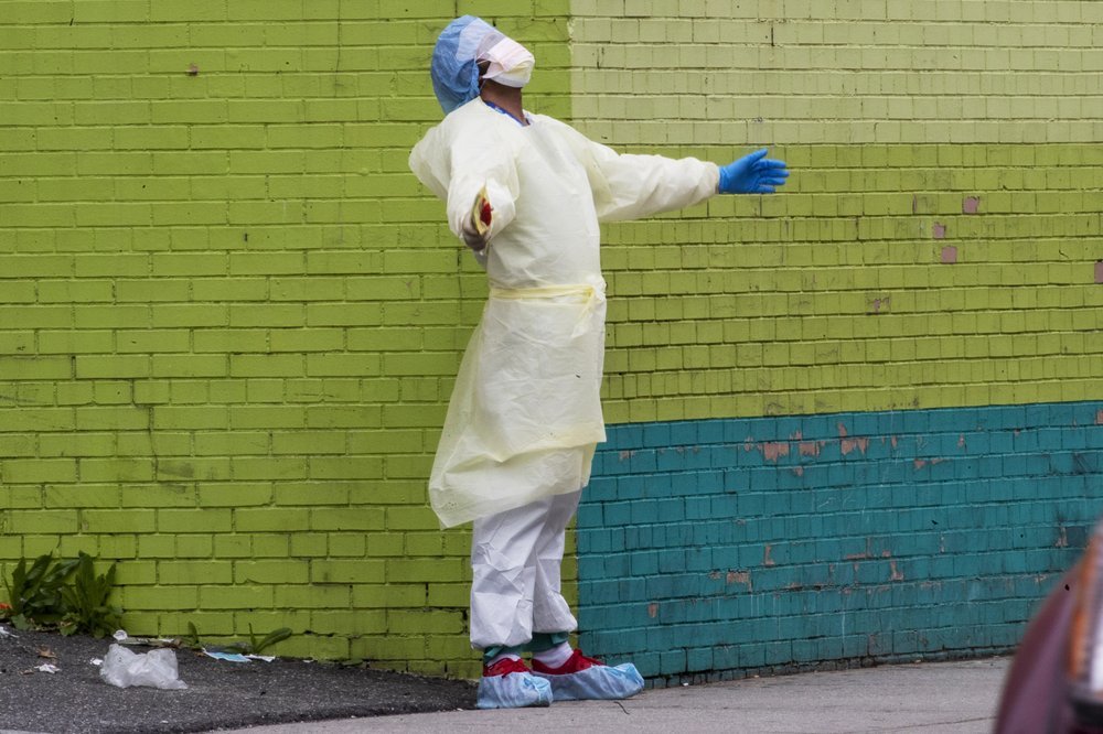A medic of the Elmhurst Hospital Center medical team reacts after stepping outside of the emergency room in the Queens borough of New York. — AP)