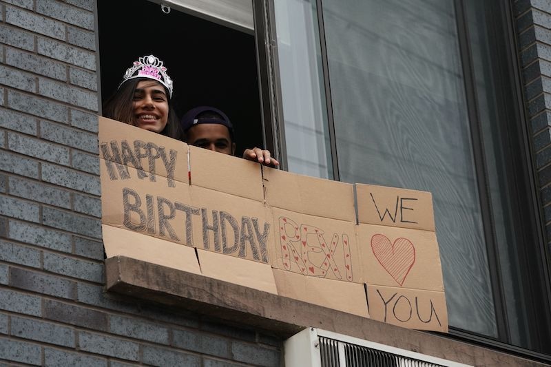 Rexi holds a sign delivered by friends on her 32nd birthday while adhering to the social distancing advisory in the Bushwick section of Brooklyn on April 5, 2020 in New York. The coronavirus death toll in New York state spiked to 4,159, the governor said, up from 3,565 a day prior. The toll increase of 594 showed a slight decrease in the day-to-day number of lives lost compared to the previous day. &mdash; AFP