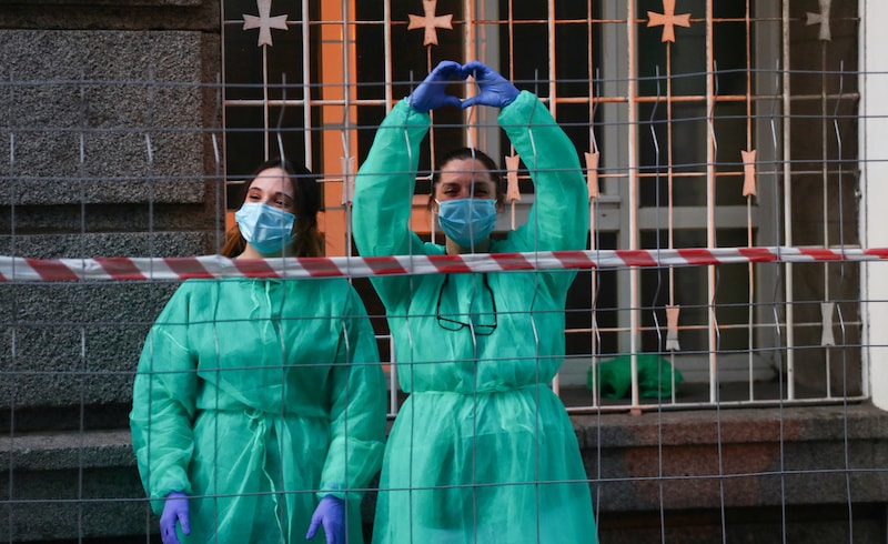 Medical staff from La Princesa hospital react as neighbours applaud from their balconies in support for healthcare workers, amid the coronavirus disease outbreak, in Madrid, Spain on April 5, 2020. — Reuters