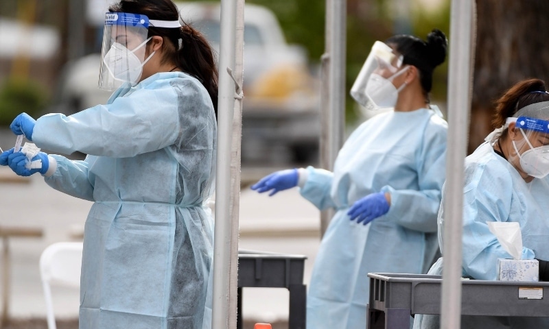 Certified medical assistants conduct tests for Covid-19 at a drive-thru testing station in the parking lot of UNLV Medicine on April 6 in Nevada. — AFP