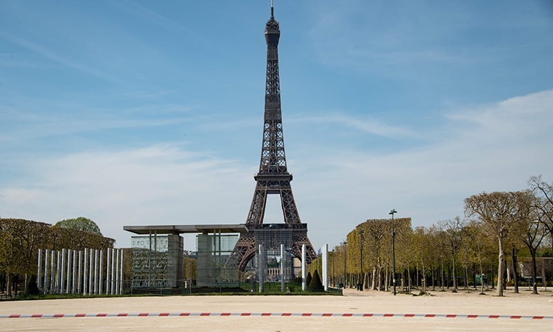 The closed Jardin du Champs de Mars garden is seen in front of the Eiffel tower in Paris on Tuesday. — AFP