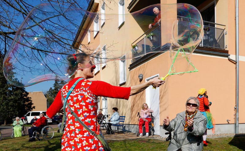 Circus clown Tanja Selmer performs for seniors at their retirement home, as the spread of the coronavirus disease continues in Jueterbog, south of Berlin, Germany on April 7, 2020. — Reuters
