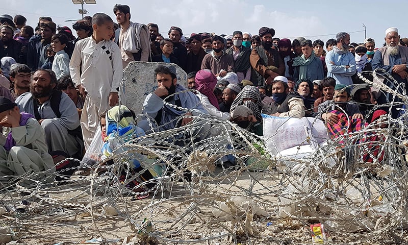 Afghan nationals wait to cross Pakistan and Afghanistan border at Chaman. — AFP