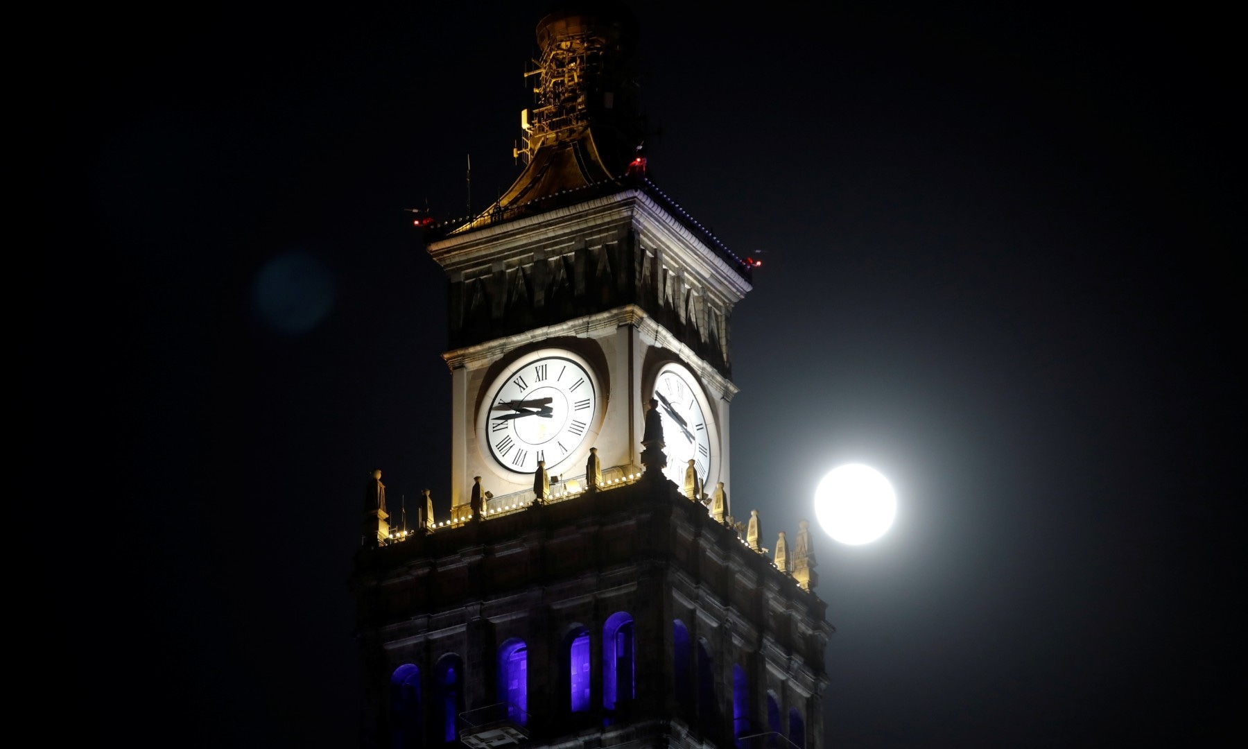 The pink supermoon, the biggest full moon of 2020, is seen behind Palace of Culture and Science, in Warsaw on April 7. &mdash; Reuters