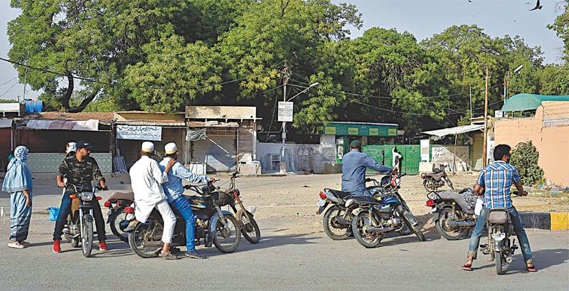 PEOPLE arriving at the Sakhi Hasan graveyard to pay respect to their deceased family members find the gates closed -photo by Fahim Siddiqi