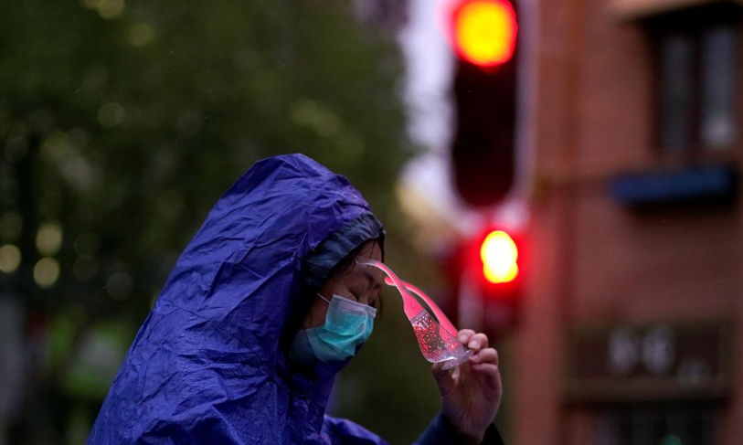 A woman wearing a face mask is seen on a street after the lockdown was lifted in Wuhan, the capital of Hubei province and China's epicentre of Covid-19 outbreak, April 10. &mdash; Reuters