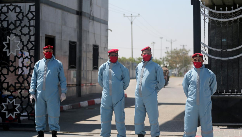 Members of Palestinian Hamas security forces wear protective gear as precaution against Covid-19 at Rafah border crossing in the southern Gaza Strip, April 13. — Reuters