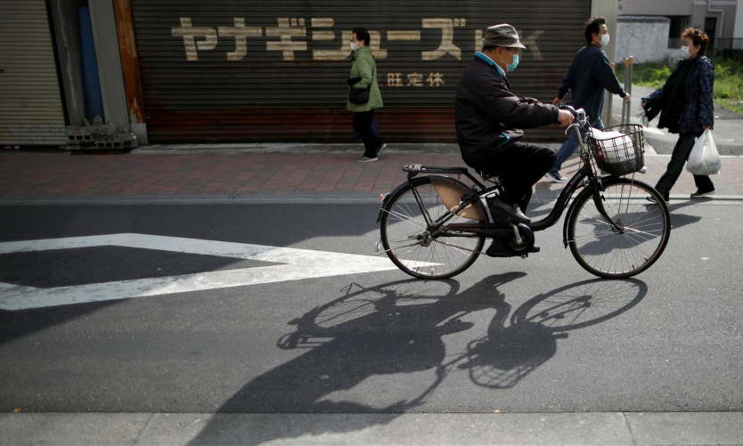 People wearing protective face masks walk on the street after the government announced state of emergency for the capital and some prefectures following Covid-19 outbreak at Sugamo district, an area popular among the Japanese elderly, in Tokyo, Japan April 15. — Reuters
