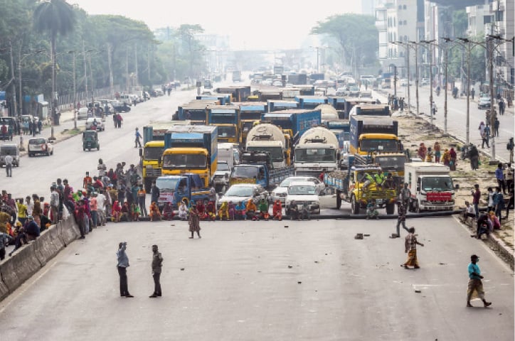 Workers from the garment sector block a road in Dhaka during a protest to demand payment of wages. Thousands of garment workers who produce items for top Western fast fashion brands took to Bangladesh&rsquo;s streets to protest against unpaid wages, saying they were more afraid of starving than contracting the coronavirus.&mdash;AFP