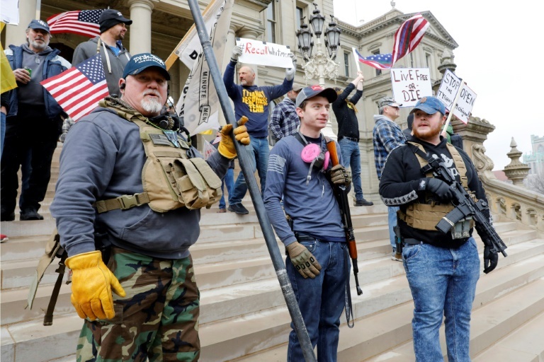 People take part in a protest for "Michiganders Against Excessive Quarantine" at the Michigan State Capitol in Lansing. — AFP