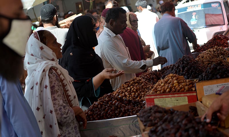 Residents buy dates at a market ahead of Ramazan in Karachi on April 20. &mdash; AFP