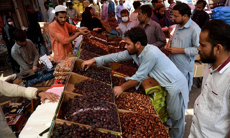Residents buy dates at a market ahead of Ramazan during a nationwide lockdown in Karachi on April 20. &mdash; AFP