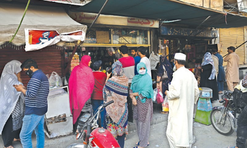 SHOPPERS ignore social distancing at Allama Iqbal Road.&mdash;White Star