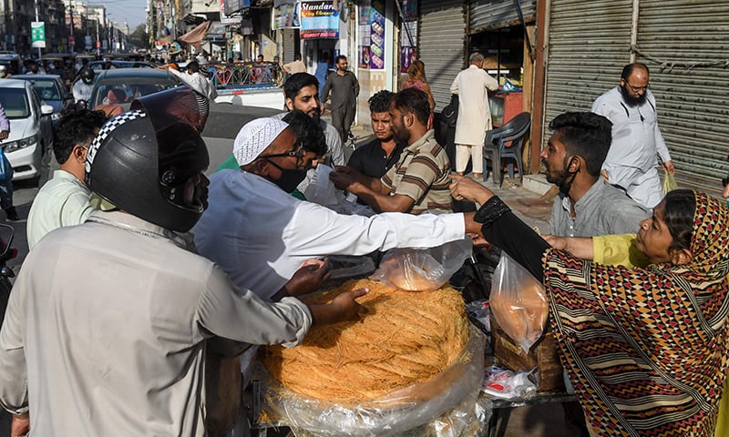 People buy vermicelli from a roadside vendor ahead of Ramazan in Karachi on April 24. &mdash; AFP