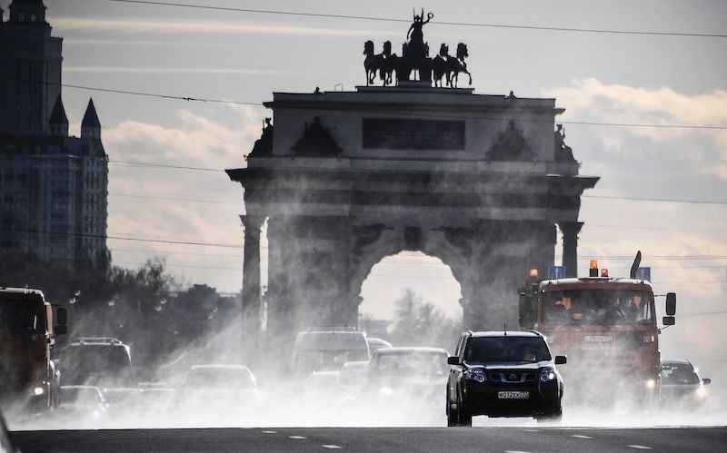 TOPSHOT - Municipal vehicles clean and disinfect a street in downtown Moscow on April 23, 2020, during the COVID-19 outbreak, caused by the novel coronavirus. (Photo by Alexander NEMENOV / AFP) &mdash; AFP or licensors