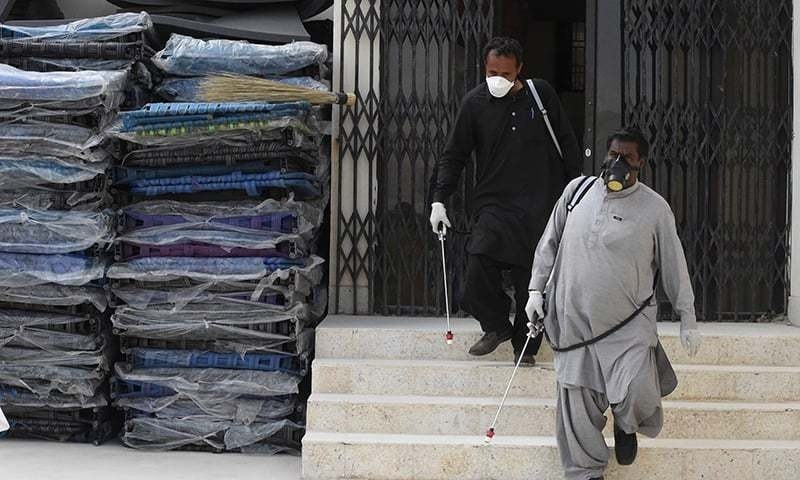 Workers of the Provincial Disaster Management Authority (PDMA) of Balochistan arrive to spray disinfectant at a quarantine camp, prepared for people returning from Iran via the Pakistan-Iran border town of Taftan to prevent the spread the Covid-19 coronavirus, on the outskirts of Quetta on March 9, 2020. &mdash; AFP/File
