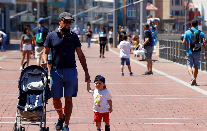 Children walk with their parents at promenade of Las Canteras beach after restrictions were partially lifted for children for the first time in six weeks, following Covid-19 outbreak on the island of Gran Canaria, Spain, April 26. — Reuters