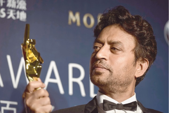 Irrfan Khan poses with his trophy for the best actor at the Asian Film Awards in Macau in this March 27, 2014, photo.&mdash;AFP