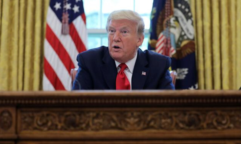 US President Donald Trump answers questions during an interview about the coronavirus pandemic  in the Oval Office of the White House in Washington, US. — Reuters