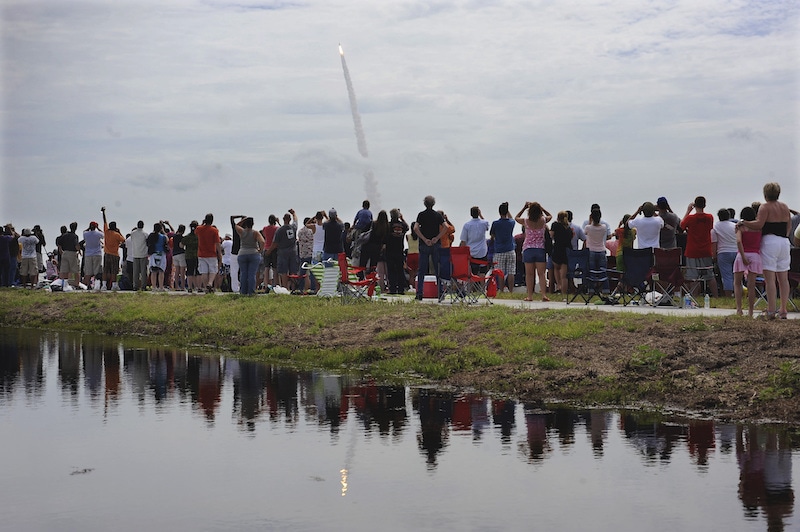 Spectators watch the space shuttle Atlantis lift off from the Kennedy Space Center Friday, July 8, 2011, in Cape Canaveral, Florida. Atlantis is the 135th and final space shuttle launch for NASA. — AP