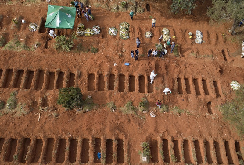 Cemetery workers in protective clothing bury a person who died of COVID-19 at the Vila Formosa cemetery in Sao Paulo, Brazil, Thursday, April 30, 2020. (AP Photo/Andre Penner) &mdash; Copyright 2020 The Associated Press. All rights reserved.
