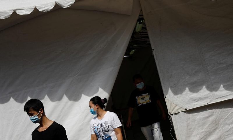 In this file photo, people leave a tent used as a thermal scanning station, while buying groceries, amid the outbreak of the coronavirus in Singapore. — Reuters