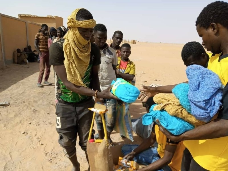 In this April 25 photo provided by IOM Niger, some of nearly 100 Nigeriens arrive in Assamaka, Niger, on foot from Algeria and now must be quarantined for two weeks at the remote Sahara border settlement. — AP