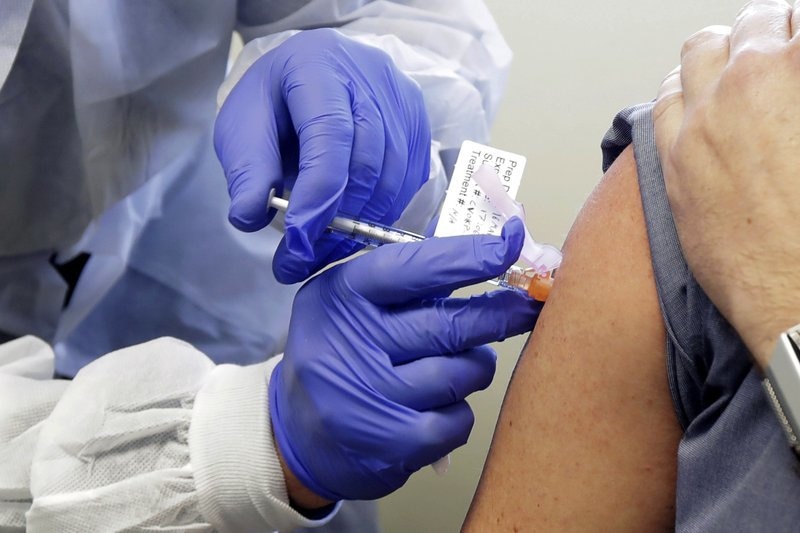 In this March 16 file photo, a patient receives a shot in the first-stage safety study clinical trial of a potential vaccine for Covid-19 at the Kaiser Permanente Washington Health Research Institute in Seattle, Washington, US. — AP