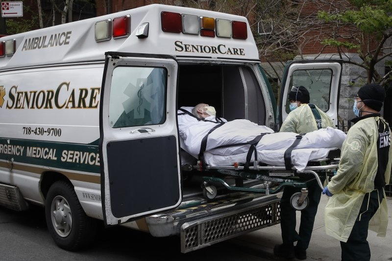 In this April 17 file photo, a patient is loaded into an ambulance by emergency medical workers outside Cobble Hill Health Centre in the Brooklyn borough of New York. &mdash; AP