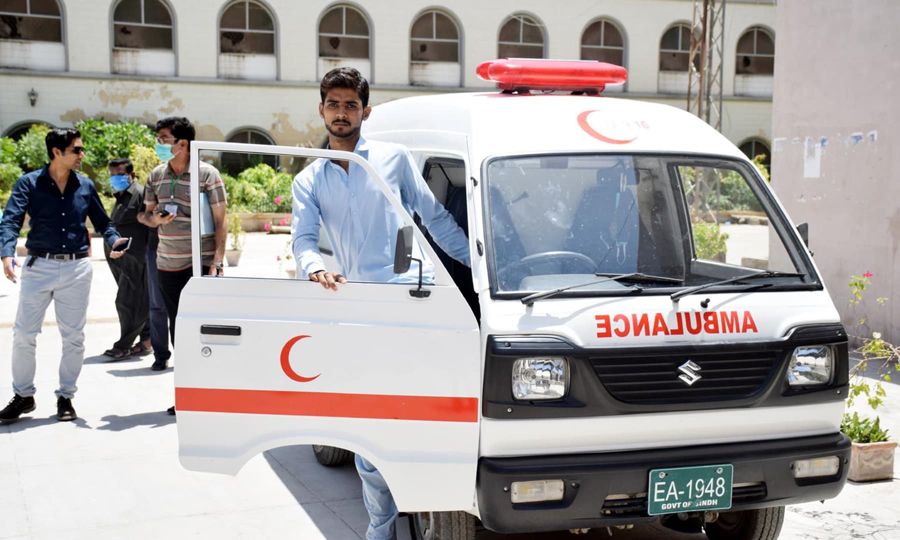 Driver Zakir Ali Mashoori sits in an ambulance. — Photo by Umair Ali