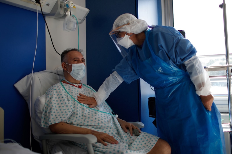 Patient Demeter talks to nurse Nabila Meharzi in the post respiratory Intensive Care Unit (ICU) for coronavirus disease (COVID-19) patients in the Robert Ballanger hospital in Aulnay-sous-Bois near Paris during the outbreak of the coronavirus disease in France, April 29, 2020. Seine-Saint-Denis, a mainly working class and multiracial suburb, was already lacking doctors and resources before the coronavirus crisis and has seen a bigger spike in mortality than neighbouring Paris. But despite being understaffed, teams at Robert Ballanger hospital reorganized to prioritize emergency health and have