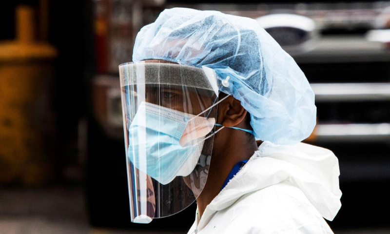 A person wearing a PPE suit exits the Elmhurst Hospital center as the outbreak of coronavirus continues in the neighbourhood of Queens in New York, US. — Reuters
