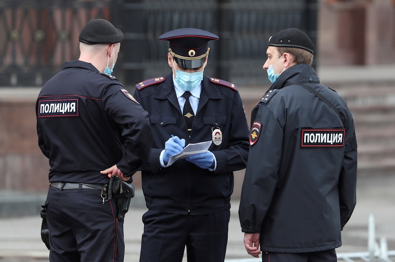 Police officers wearing protective face masks speak in a street amid the outbreak of the coronavirus in Moscow, Russia, on May 6, 2020. — Reuters