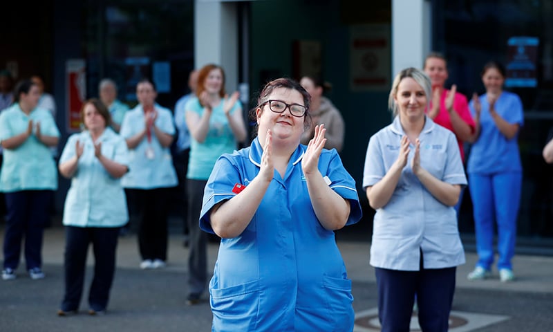NHS workers react at the Nightingale Hospital during the Clap for our Carers campaign in support of the NHS, in Belfast, Northern Ireland. — Reuters