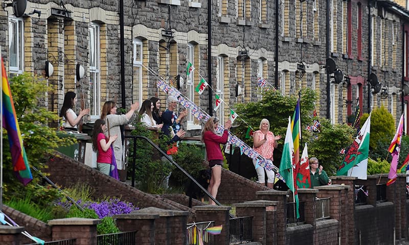 People applaud in support of the NHS during the Clap for our Carers campaign in Wattsville, Wales, Britain. — Reuters