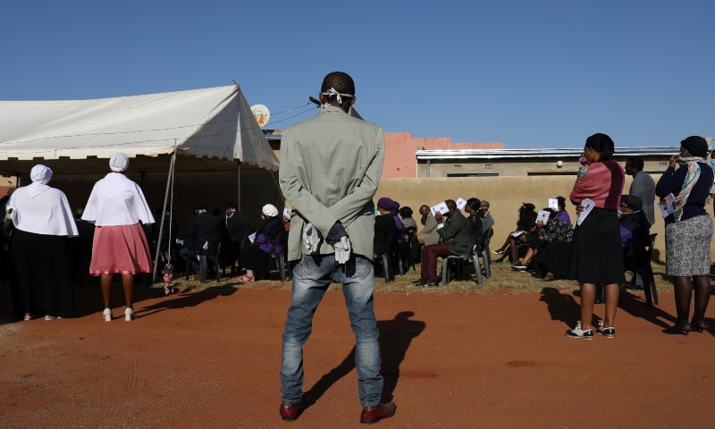 Mourners keep a safe distance during the funeral service of 63-year-old Mary Modimola, as centuries-old cultural traditions at funerals are being forgone due to the outbreak of Covid-19. &mdash; Reuters