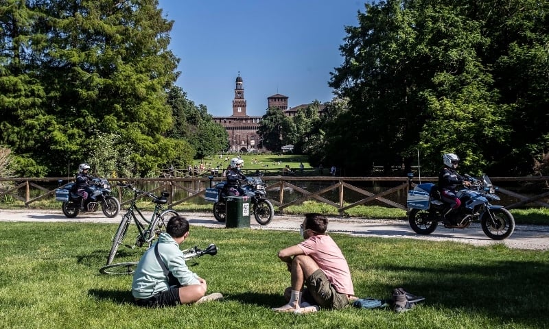Police officers patrol Sempione public park in Milan on May 7. — AP