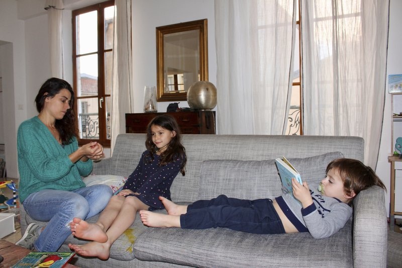 In this photo taken on April 30, Mathilde Manaud plays on a sofa with her children Mila, 7, and Andre, 3, in Paris. As France prepares to start letting public life resume after eight weeks, many parents are deeply torn over a question without a clear or conclusive answer: Should I send my child back to school? — AP
