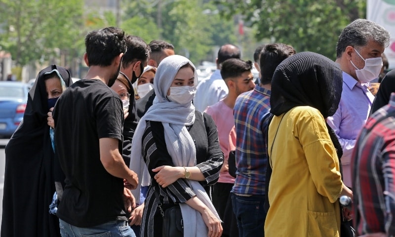 Iranians queue outside a money exchange office in Tehran on May 9. — AFP