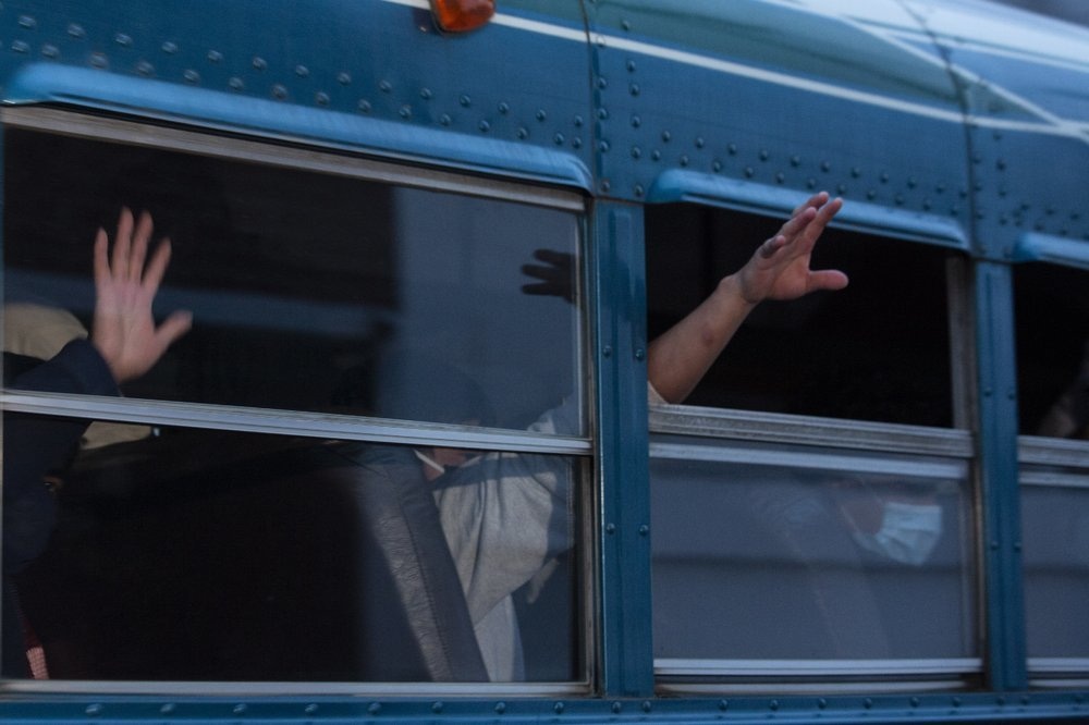 In this May 4 file photo, Guatemalans deported from the US wave from a bus after arriving at La Aurora airport in Guatemala City. — AP