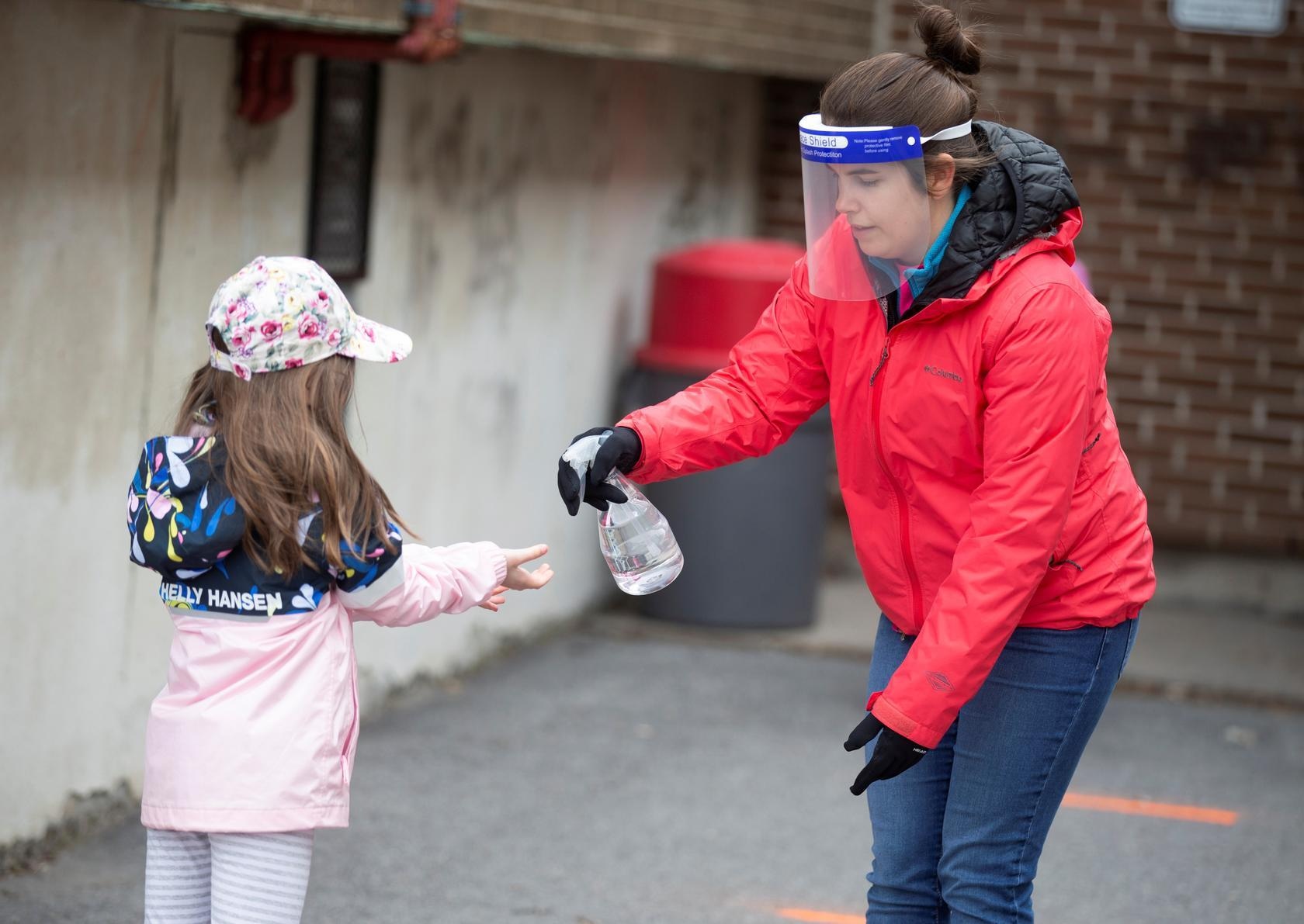 A student has her hands sanitised in the schoolyard in Saint-Jean-sur-Richelieu, Quebec, Canada, May 11. &mdash; Reuters