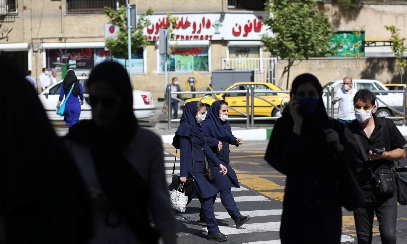 ranians wear protective face masks and gloves in Tehran on May 12. &mdash; Reuters