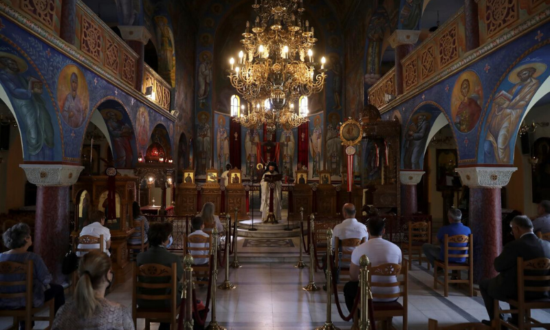 Orthodox faithful respect social distancing as they attend the first service open for believers following the easing of measures against the spread of the coronavirus in Athens, Greece. — Reuters