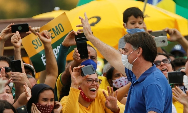 Brazil's President Jair Bolsonaro greets supporters during a protest against the President of the Chamber of Deputies Rodrigo Maia on May 17. &mdash;  Reuters