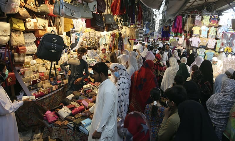 People shop in a market after the government relaxed the weeks-long lockdown that was enforced to curb the spread of the new coronavirus, in Peshawar, Pakistan. &mdash; AP/File
