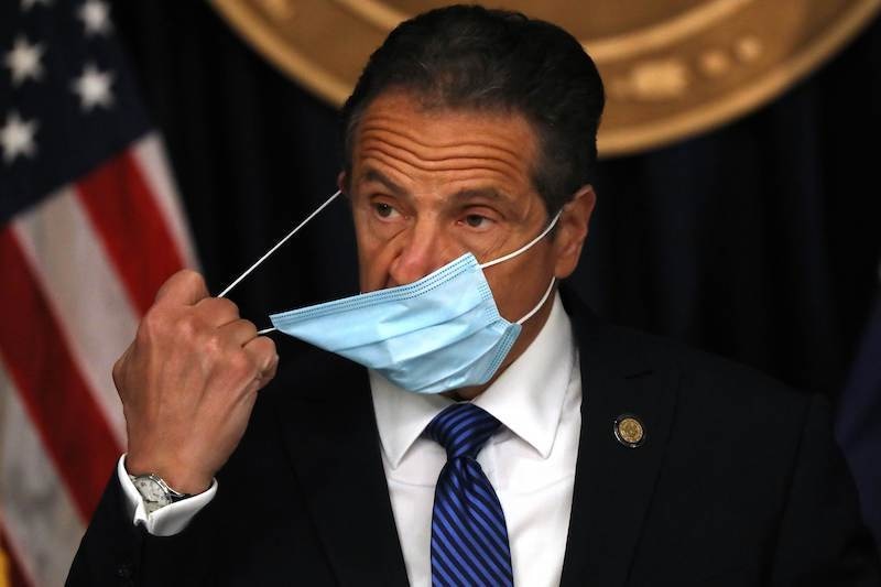 New York Governor Andrew Cuomo arrives with a face mask at a news conference on May 21, 2020, in New York City. While the governor continued to say that New York City is seeing a steady decline in coronavirus cases, he also mentioned that the number of countries reporting a mysterious illness in children believed to be connected to Covid-19 has nearly doubled in just one week. — AFP