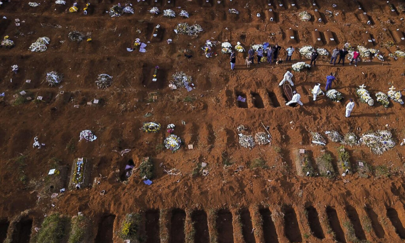 Gravediggers wearing protective suits bury a coffin during the outbreak of the coronavirus at Brazil's biggest cemetery in Sao Paulo. — Reuters