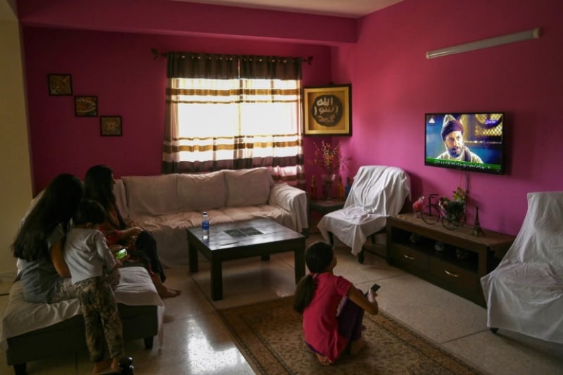 A Pakistani family enjoys the show Resurrection: Ertugrul in the capital Islamabad- AFP / Aamir Qureshi