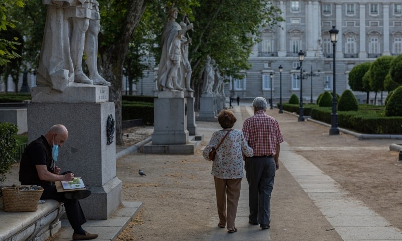 A man paints near the Royal palace in Madrid on May 24. &mdash; AP